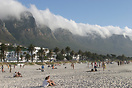 The beach at Camps Bay overlooked by the mountain draped in cloud know...
