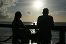 Sunset Beach Bar and a couple enjoying a beer and watching the sun go ...