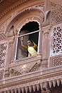 A woman stands in a window at the Mehrangarh Fort Jodhpur