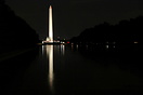 The Washington Monument at night with the U.S. Capitol building in the... The Washington Monument at night with the U.S. Capitol building in the...