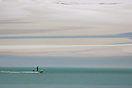 Small boat in Whitehaven beach at low tide.