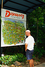 Tourist looking at a overview map of the Daintree Discovery Centre. Fa...