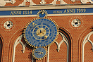 a close up showing the large clock on the Town Hall in Riga