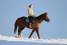 A girl rides through the snow on horseback in Chateau D'Oex
