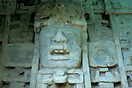 A huge stylized mask of a man in a crocodile mouth head dress that is ...