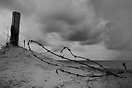 Seemingly frozen in time, barbed wire still guards the entrance to Oma...