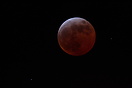 Pictured during "totality" when the moon appears reddish in ...