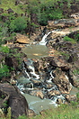 Small waterfalls connect a series of pools that the river has carved o...