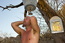 Enjoying an early morning bucket shower in the bush