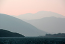 A hazy morning on Loch Broom reveals the many layers of mountains.