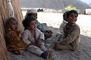 Young children sheltering in the shade, Hurghada, Egypt