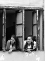 Two girls watch a passing wedding party in Holguin, Cuba.