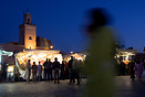 A woman walking through the Jemaa el Fna square