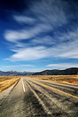 Cirrus clouds watch over a lonely stretch of Idaho highway, close to t...