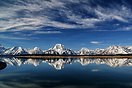 A veil of cirrus clouds forms over the Teton Mountains.