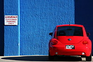 A red Volkswagen against a blue wall, Salida, Colorado.