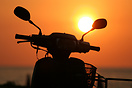 A local parks up to admire the setting sun at Phuket. 