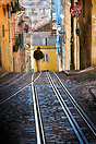 A man walking through the streets of the Barrio Alto in Lisbon