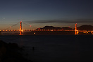 Night time view of the Golden Gate Bridge spanning San Francisco Bay