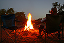 Relaxing by the fire enjoying a drink while on safari in the Chobe Nat...