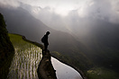 A boy looking at the rice terraces of Batad at dawn