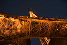 A view from beneath the Eiffel Tower at night.